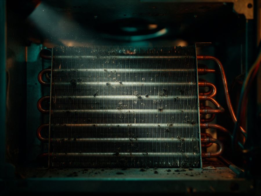A grimy HVAC coil with dust and mold